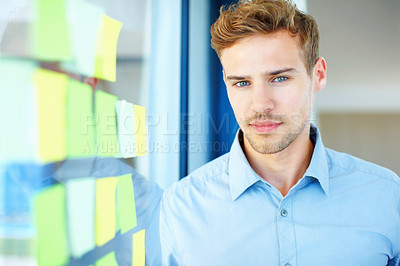 Buy stock photo Handsome business man with adhesive notes stuck to the glass