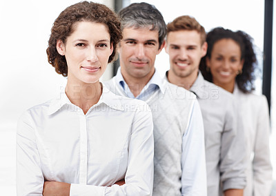 Buy stock photo Portrait of a young female professional with her coworkers standing behind her