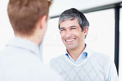 Buy stock photo Shot of two businessmen talking together at work