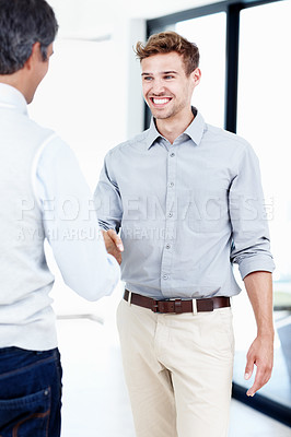 Buy stock photo Shot of two positive-looking businessmen shaking hands