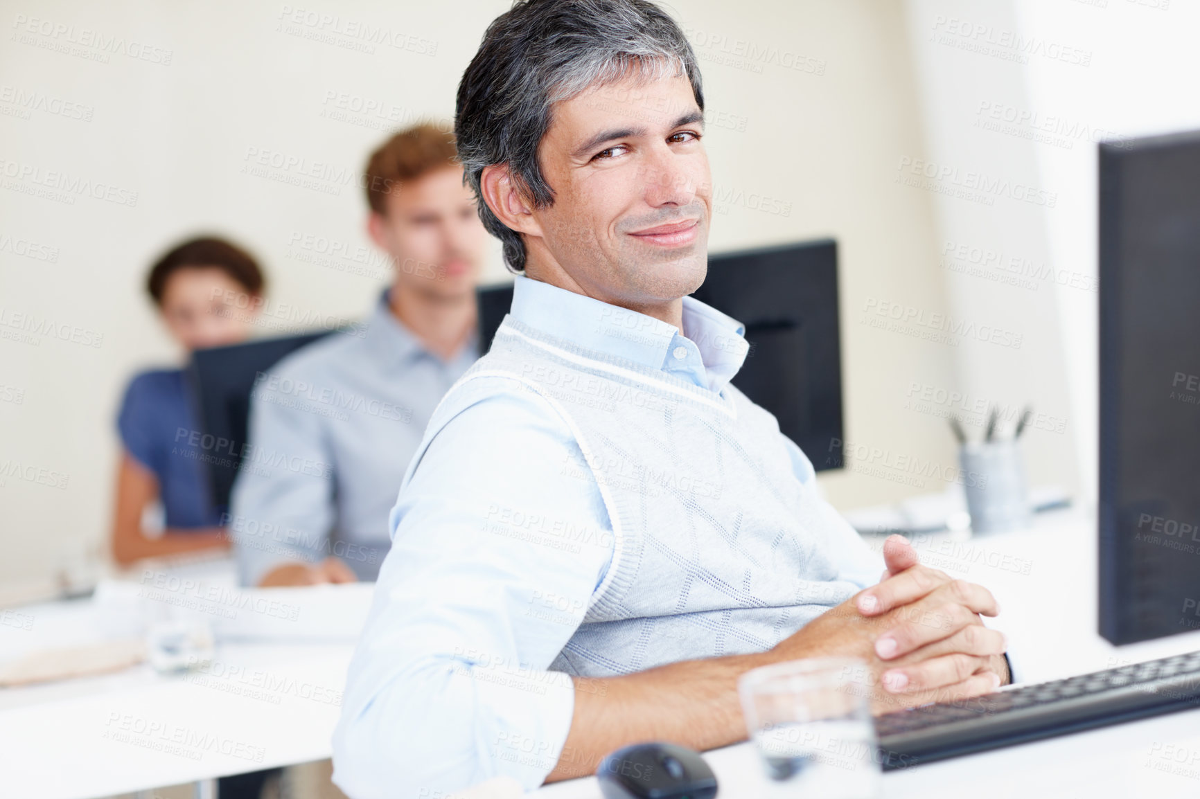 Buy stock photo Employee, office and mature man with smile at desk with computer as project manager. Male person, coworking and happy on portrait with confidence as team leader with pride for career and skill growth