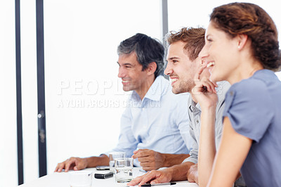 Buy stock photo Profile shot of three positive-looking businesspeople sitting in an office
