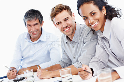 Buy stock photo Portrait shot of three positive-looking businesspeople sitting in an office