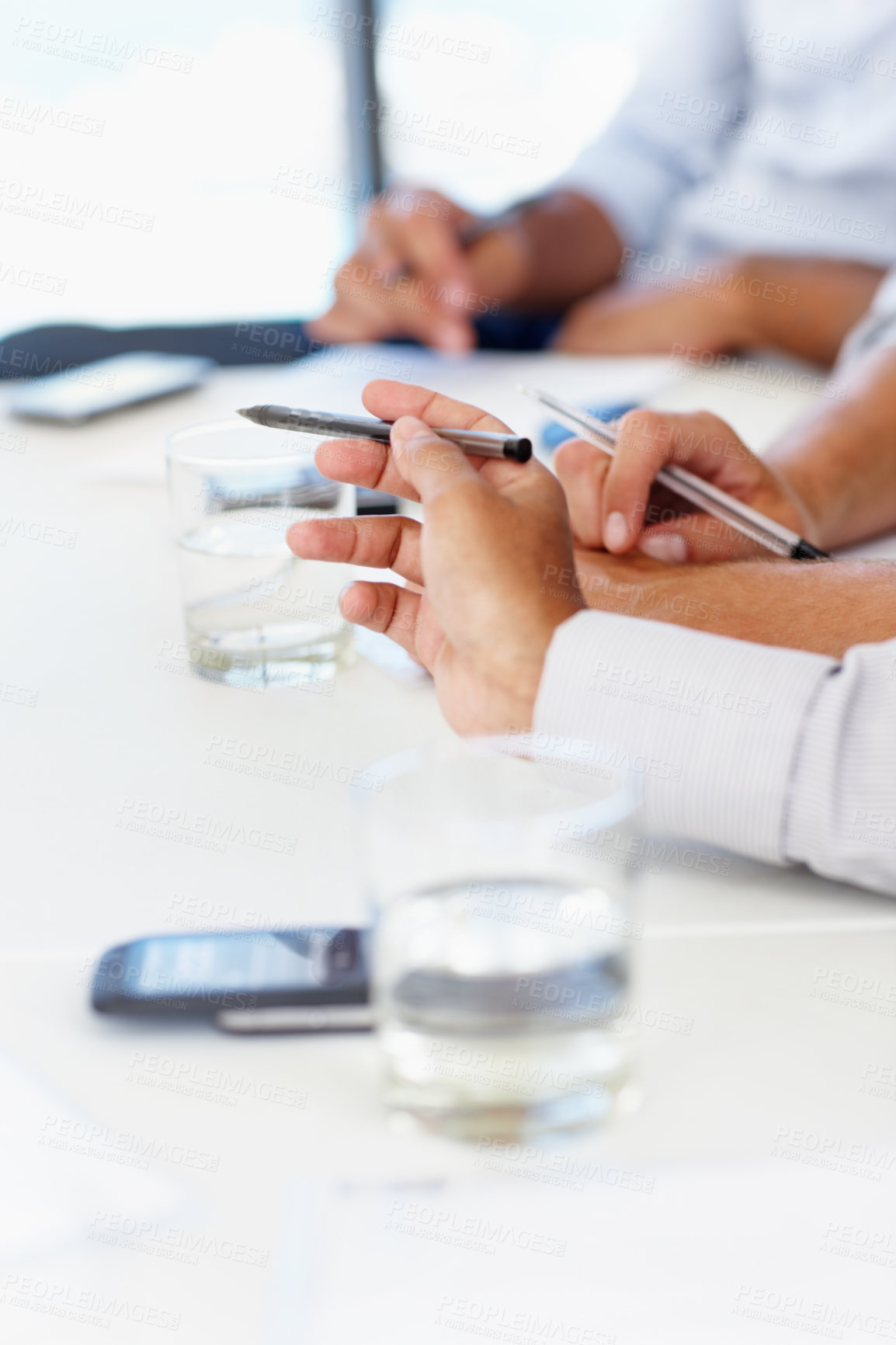 Buy stock photo Hands, meeting and pen with business people at table in boardroom of office together for planning. Collaboration, explain and workshop with employee group in professional workplace for administration