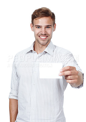 Buy stock photo Copyspace of a confident man marketing or presenting an endorsed message. Portrait of a young man in a shirt holding a blank white piece of paper isolated on a white studio background and smiling. 