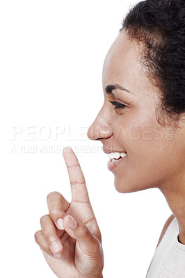 Buy stock photo Studio shot of a young woman with her finger on her lips isolated on white