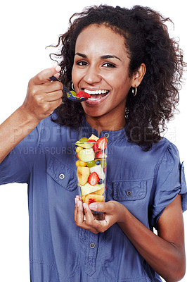 Buy stock photo Studio portrait of a smiling woman eating fruit salad isolated on white