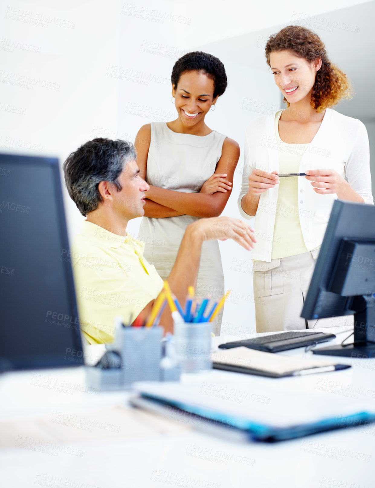 Buy stock photo Male executive sitting at table and discussing work with female colleagues