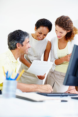 Buy stock photo Smiling business people at work with woman holding paperwork
