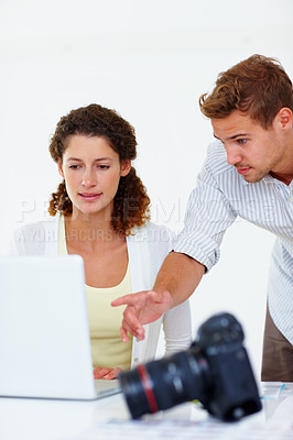 Buy stock photo Business woman using laptop with man pointing at the screen and camera in foreground