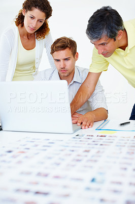 Buy stock photo Three business people using laptop and looking at the screen