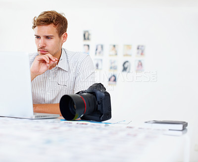Buy stock photo Business man holding glasses and using laptop with camera in foreground