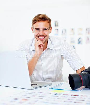 Buy stock photo Happy, man and photographer with portrait in office, camera and laptop with catalog for research trend topics. Male visual artist, creative agency and online for project management and editing photos