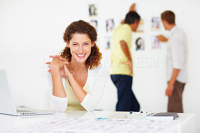 Buy stock photo Portrait of beautiful business woman using laptop and smiling with colleagues in background
