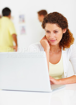 Buy stock photo Business woman using laptop with colleagues in background