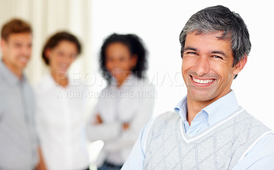 Buy stock photo Portrait of mature business man smiling with colleagues in background
