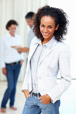 Buy stock photo Confident business woman with hands in pockets and colleagues in background