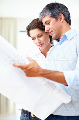 Buy stock photo Portrait of business man and woman looking at blueprint