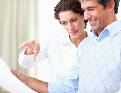 Buy stock photo Portrait of business man and woman discussing blueprint