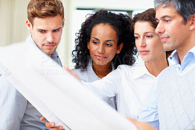 Buy stock photo Portrait of business men and women discussing blueprint at workplace