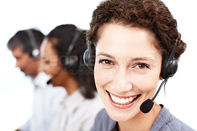 Buy stock photo Closeup portrait of a smiling call center professional with colleagues seated in the background