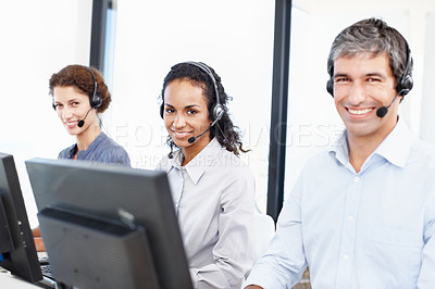 Buy stock photo Portrait of a group of call center professionals working at their computers 