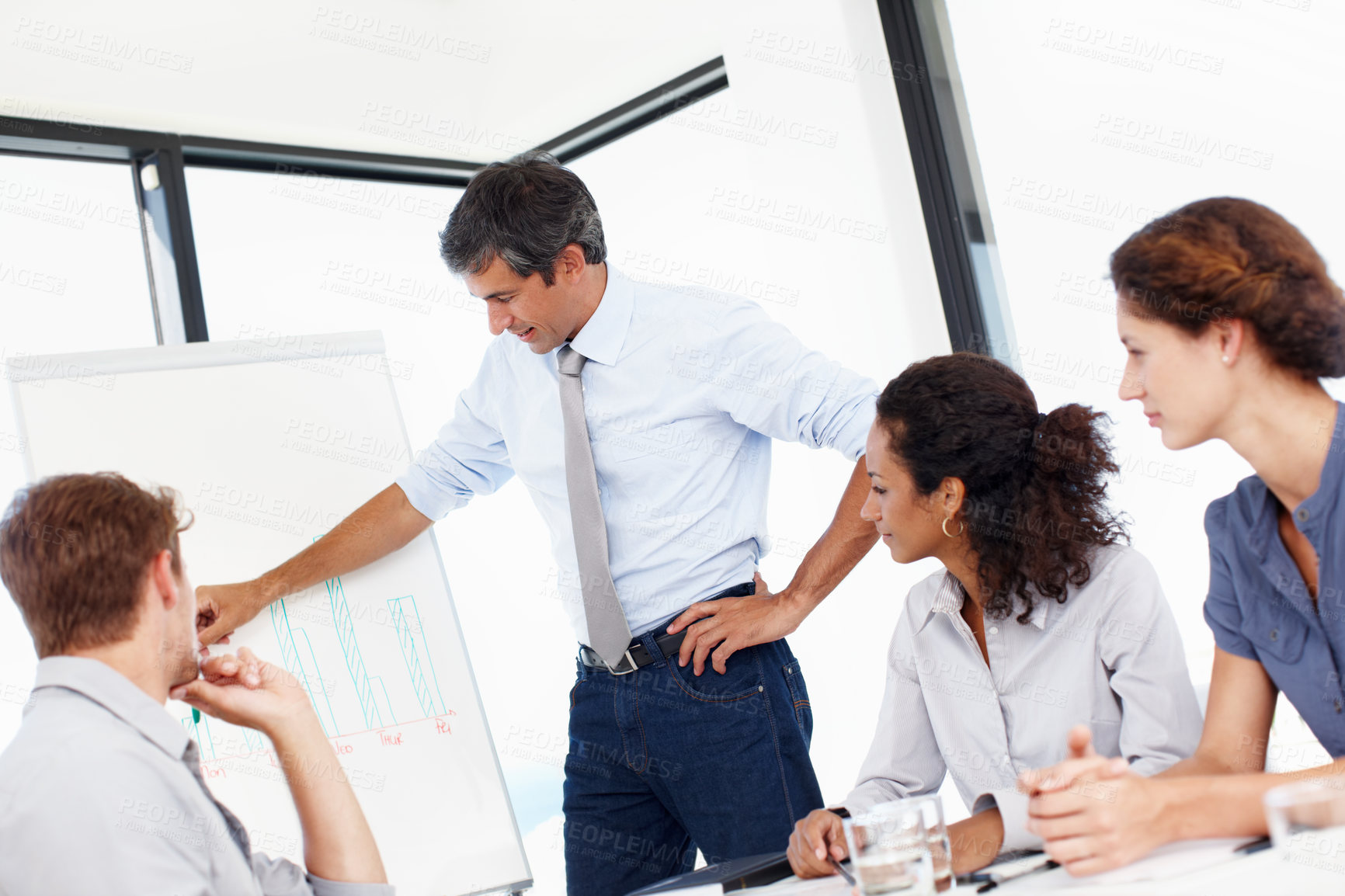 Buy stock photo Shot of a group of business people having a financial meeting in a boardroom