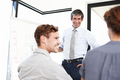 Buy stock photo Shot of a group of business people having a financial meeting in a boardroom