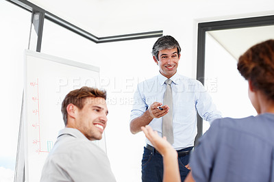 Buy stock photo Shot of a group of business people having a financial meeting in a boardroom