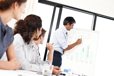 Buy stock photo Boss, charts or graphs in presentation with business people for profit analysis meeting or financial results. Writing, CEO or team in training for coaching, market share data or revenue growth advice