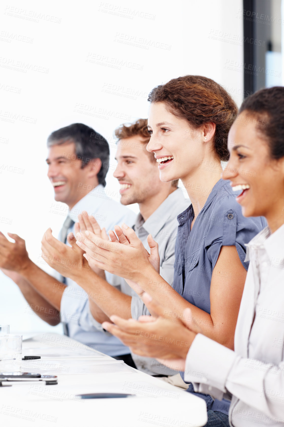 Buy stock photo Profile shot of a group of young business people clapping hands at a meeting