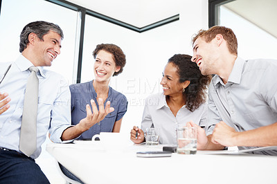Buy stock photo Shot of a group of positive-looking business people having a brainstorming session in a boardroom