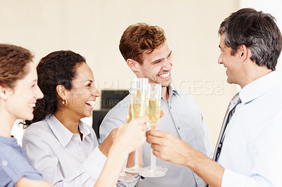 Buy stock photo Shot of a group of businesspeople toasting to their success with champagne 