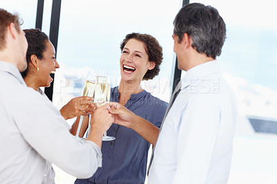 Buy stock photo Shot of a group of businesspeople toasting to their success with champagne