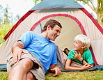 Father and son relaxing in tent