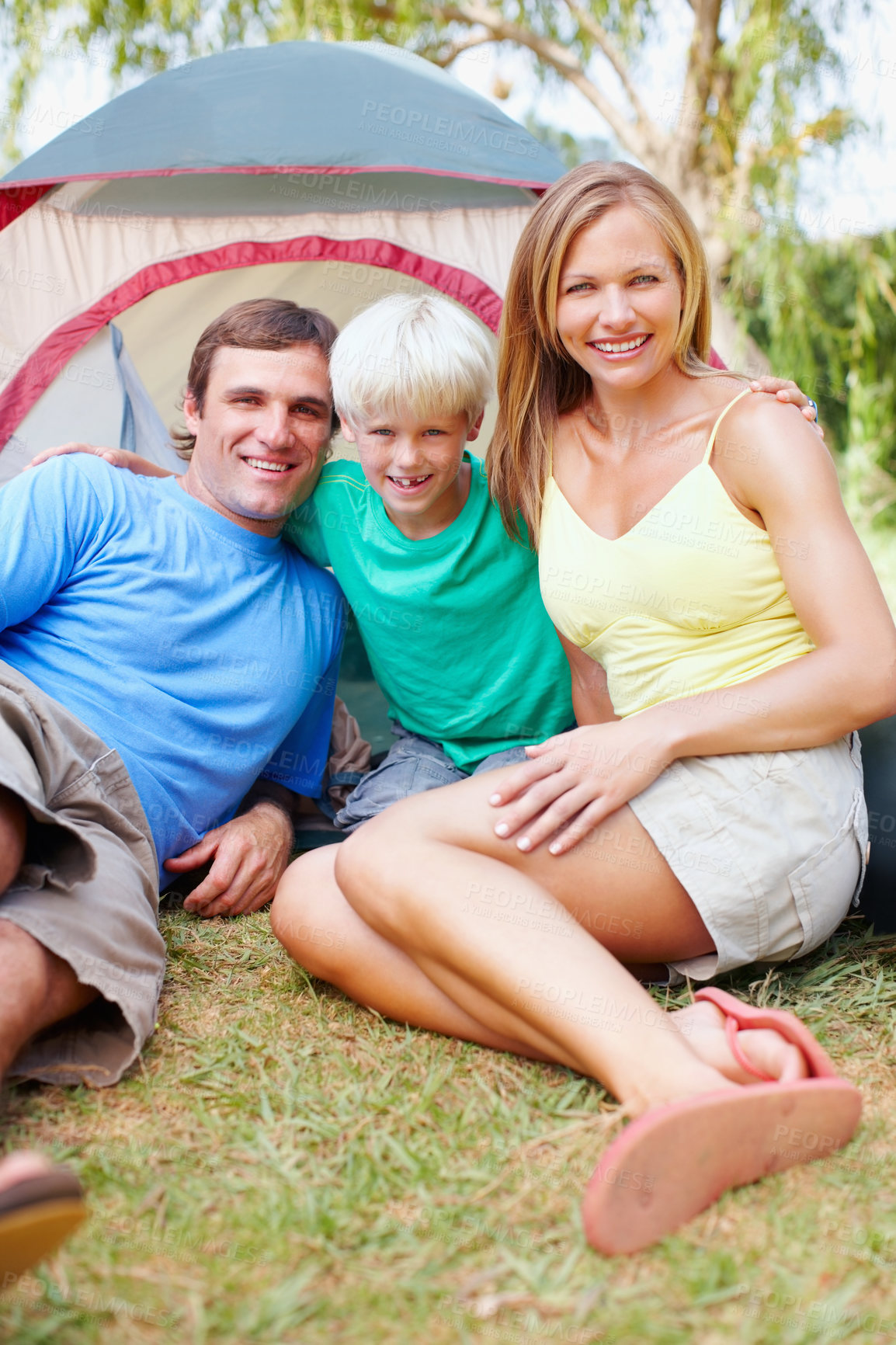 Buy stock photo Portrait of cute family of three camping in front of tent and smiling