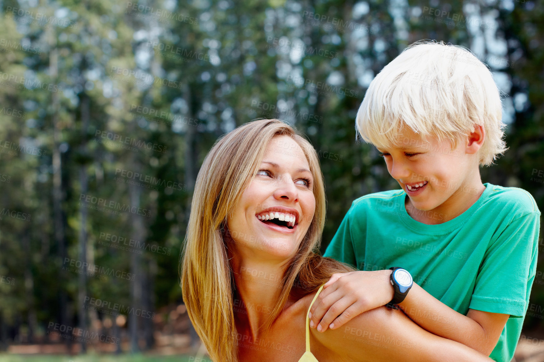 Buy stock photo Beautiful woman giving a piggyback ride to her son during holiday