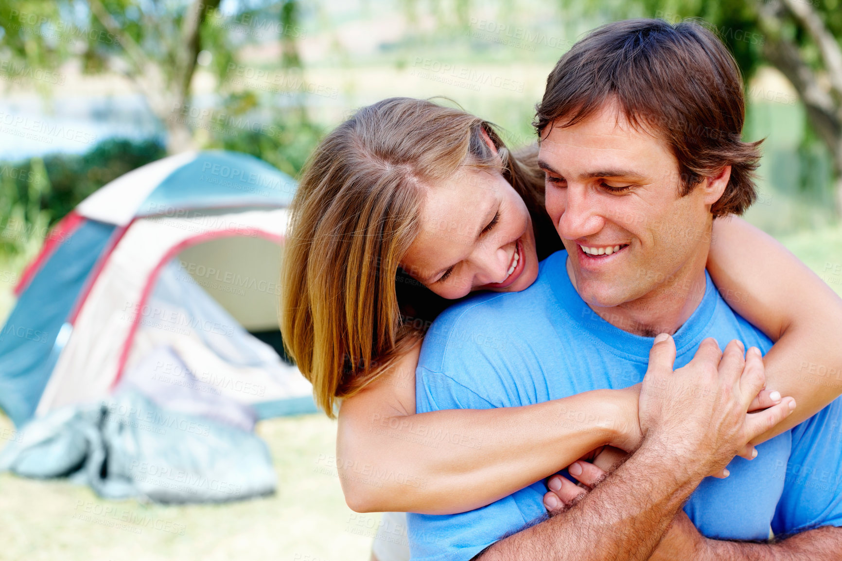 Buy stock photo Couple, hug and camping in nature for vacation, relax and travel with tent and leisure in California. People, bonding and happiness outdoor for holiday, hiking and adventure with smile by campsite 