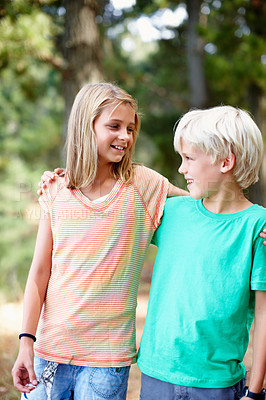 Buy stock photo Young siblings standing outdoors with arms around