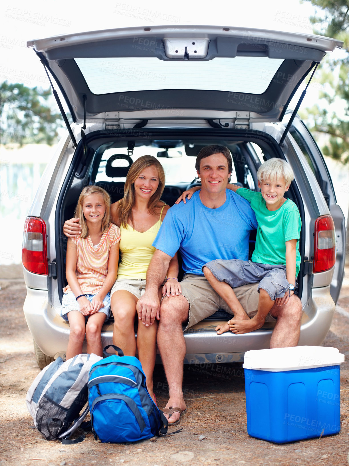 Buy stock photo Happy family, portrait and relax by car for camp in forest or outdoor, adventure and weekend trip for break. Parents, kids and together by lake in nature or wilderness for summer, holiday and bonding