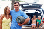 Couple enjoying vacation with kids sitting in car