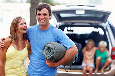 Buy stock photo Happy, man and woman with hug in outdoor for camping with family for adventure or weekend trip in mother nature. Couple, children and smile in forest or woods on summer holiday in wilderness together