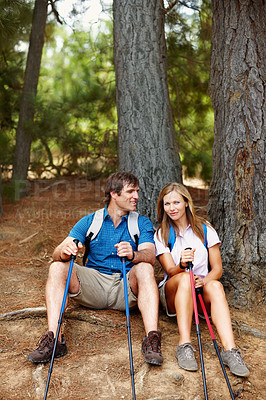 Buy stock photo Break, couple and hiking in forest, smile and adventure for vacation, man and woman with backpack. Outdoor, rest and  people with trekking poles, travel and woods with rough terrain in New Zealand