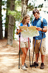 Hiking couple taking a look at map