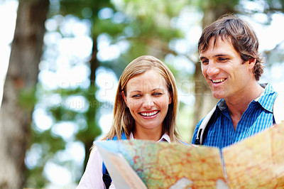 Buy stock photo Outdoor, couple and smile with map for hiking, navigation and understand terrain for destination journey. Nature, man and woman with chart for landmark, direction and route planning for trekking