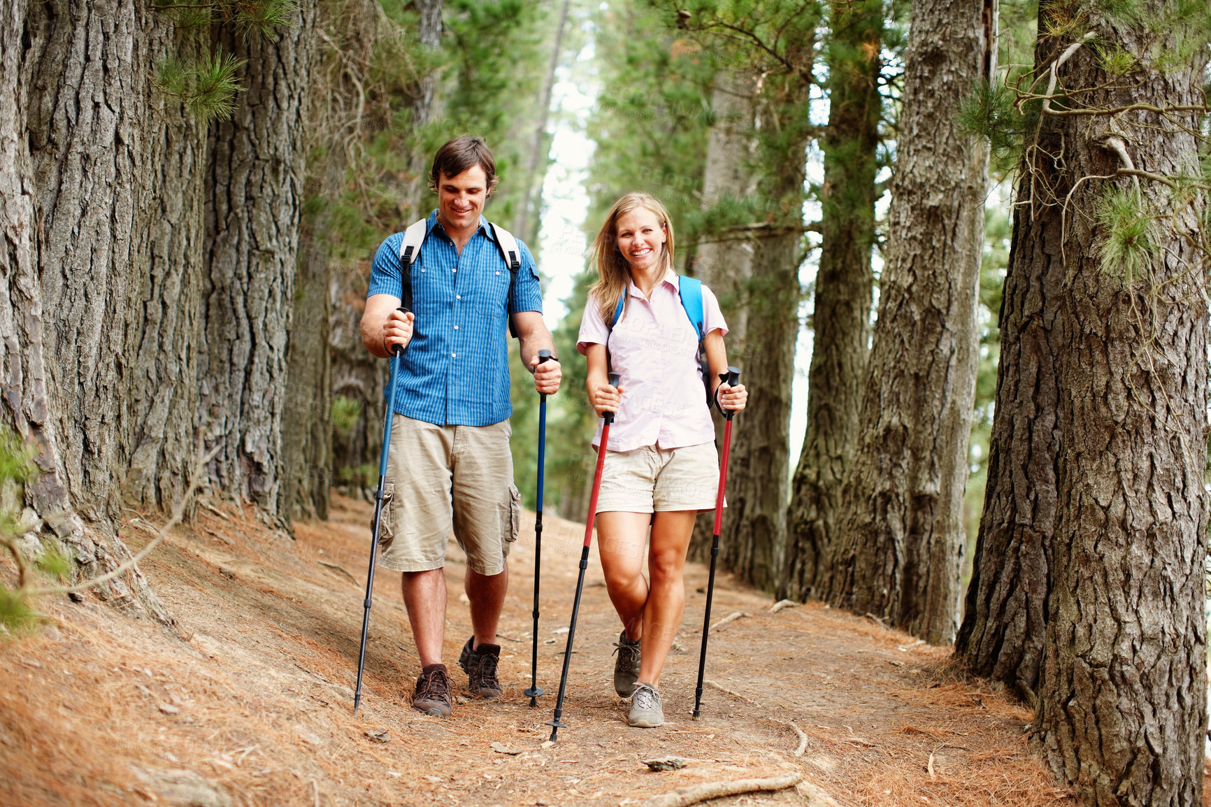 Buy stock photo Couple, hiking and gear with trekking, walk and nature for travel, adventure and bonding. Happy people, journey and countryside for discovery, fitness and exploring for recreation, outdoor and sports