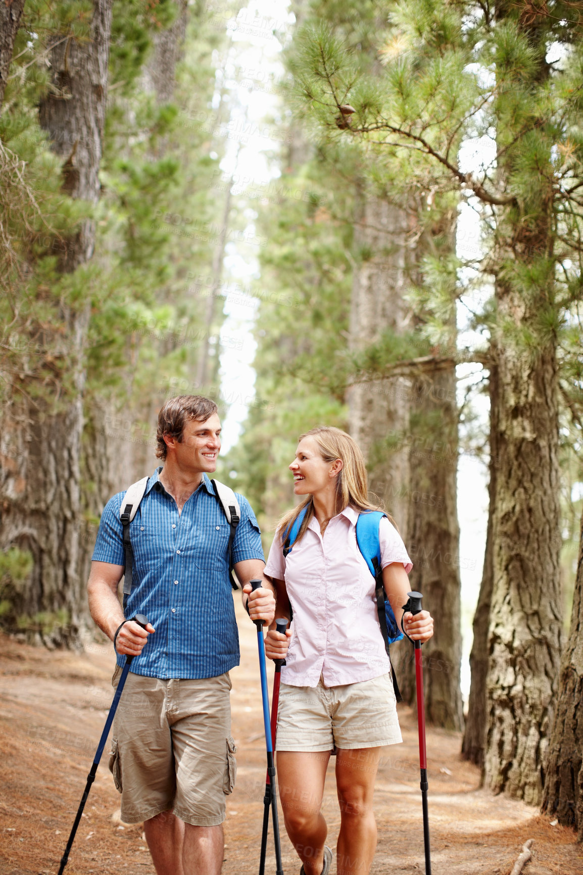 Buy stock photo Happy couple, hiking and gear with countryside, walk and nature for travel, adventure and bonding. People, journey and backpack for discovery, fitness and exploring for recreation, outdoor and sports