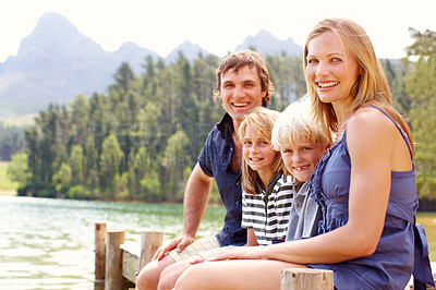 Buy stock photo Portrait, family and outdoor in nature, water and holiday for parents and children, lake and fun. Vacation, mom and dad with kids, bonding and travel to river for peace, man and woman with smile