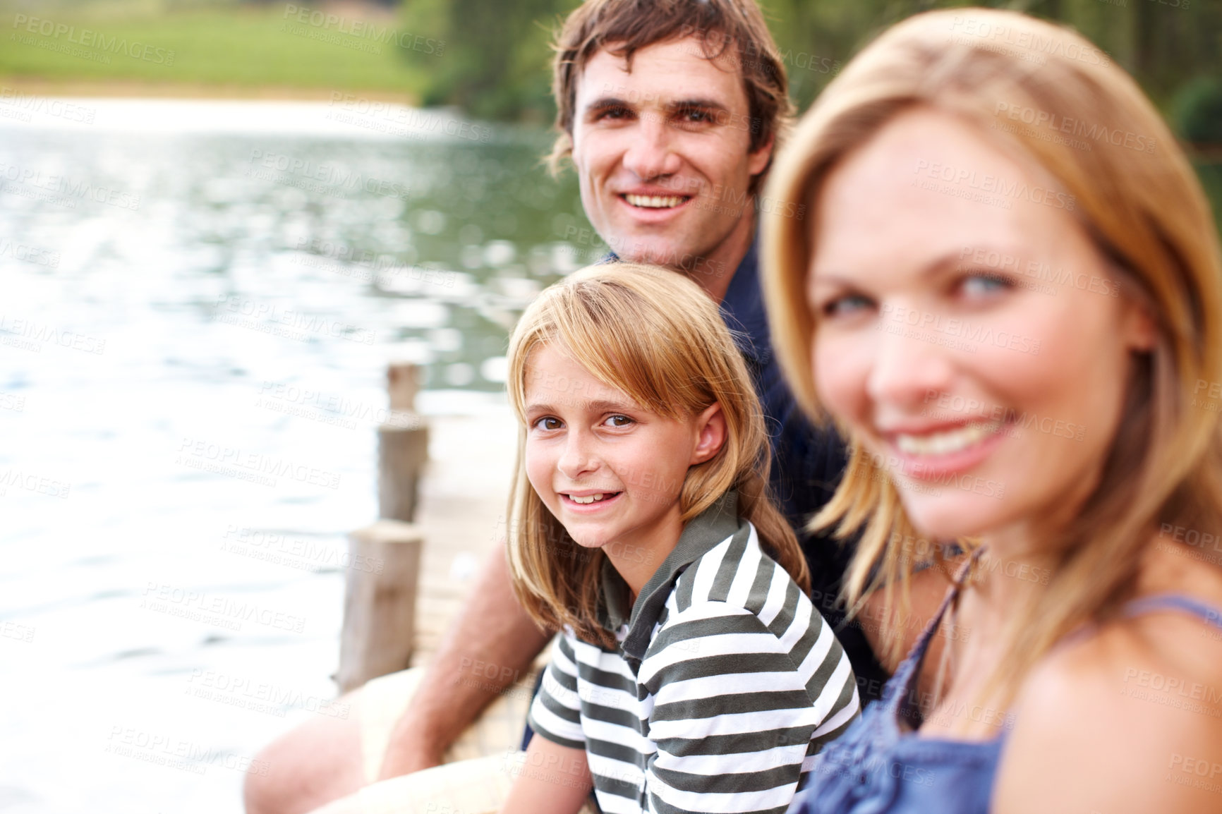 Buy stock photo Portrait, family and holiday in nature, lake and vacation for parents and child, outdoor and fun. Water, mom and dad with kid, bonding and travel to river for peace, relax and woman with man in Texas