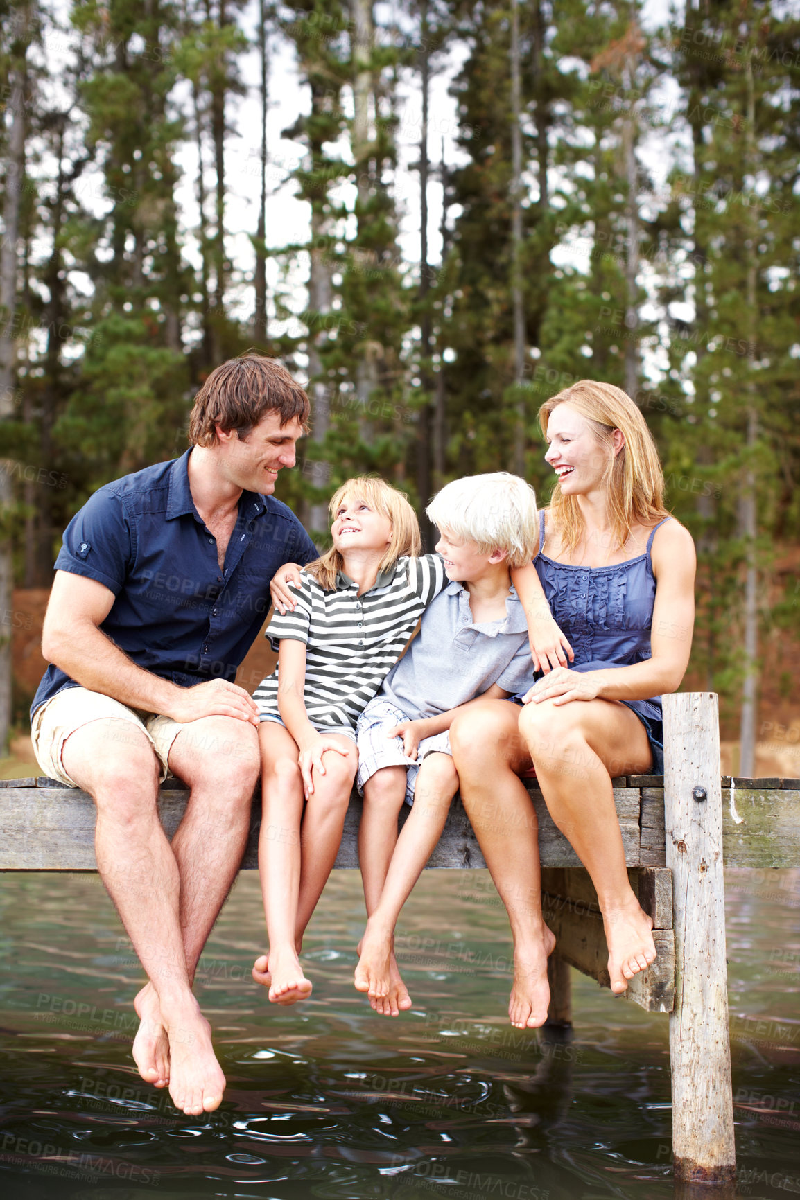 Buy stock photo Bonding, family and outdoor in nature, lake and holiday for parents and children, vacation and fun. Water, mom and dad with kids, happy and travel to river for peace, man and woman with smile